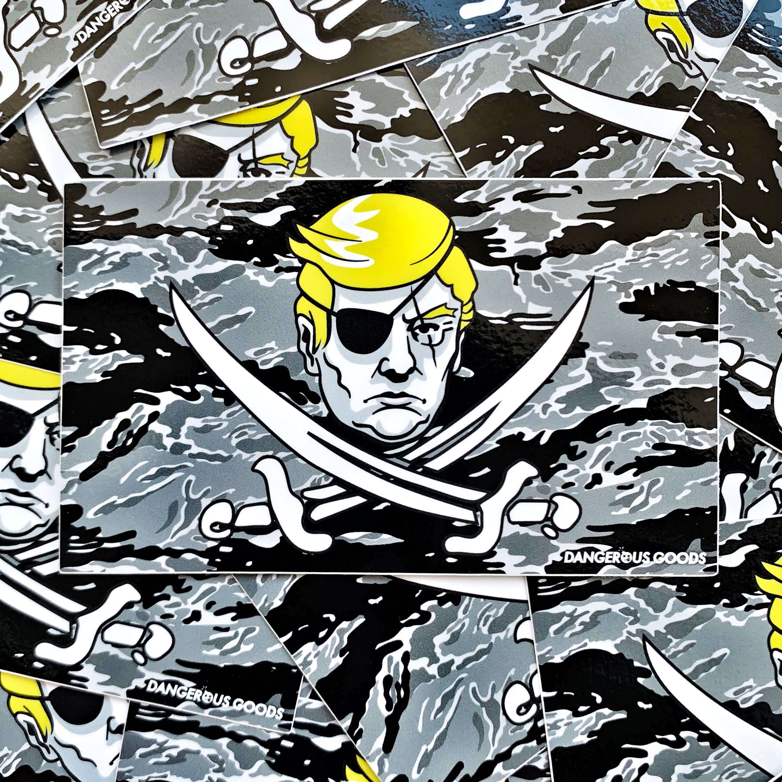 Black and grey tiger stripe camo style flag sticker depicting a cartoon image of trumps head with two crossing pirate swords underneath