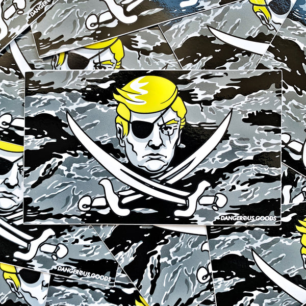Black and grey tiger stripe camo style flag sticker depicting a cartoon image of trumps head with two crossing pirate swords underneath