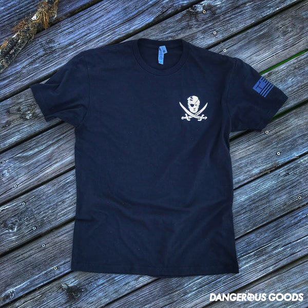 Front view of black Tshirt depicting a cartoon image of trumps head with two crossing pirate swords underneath