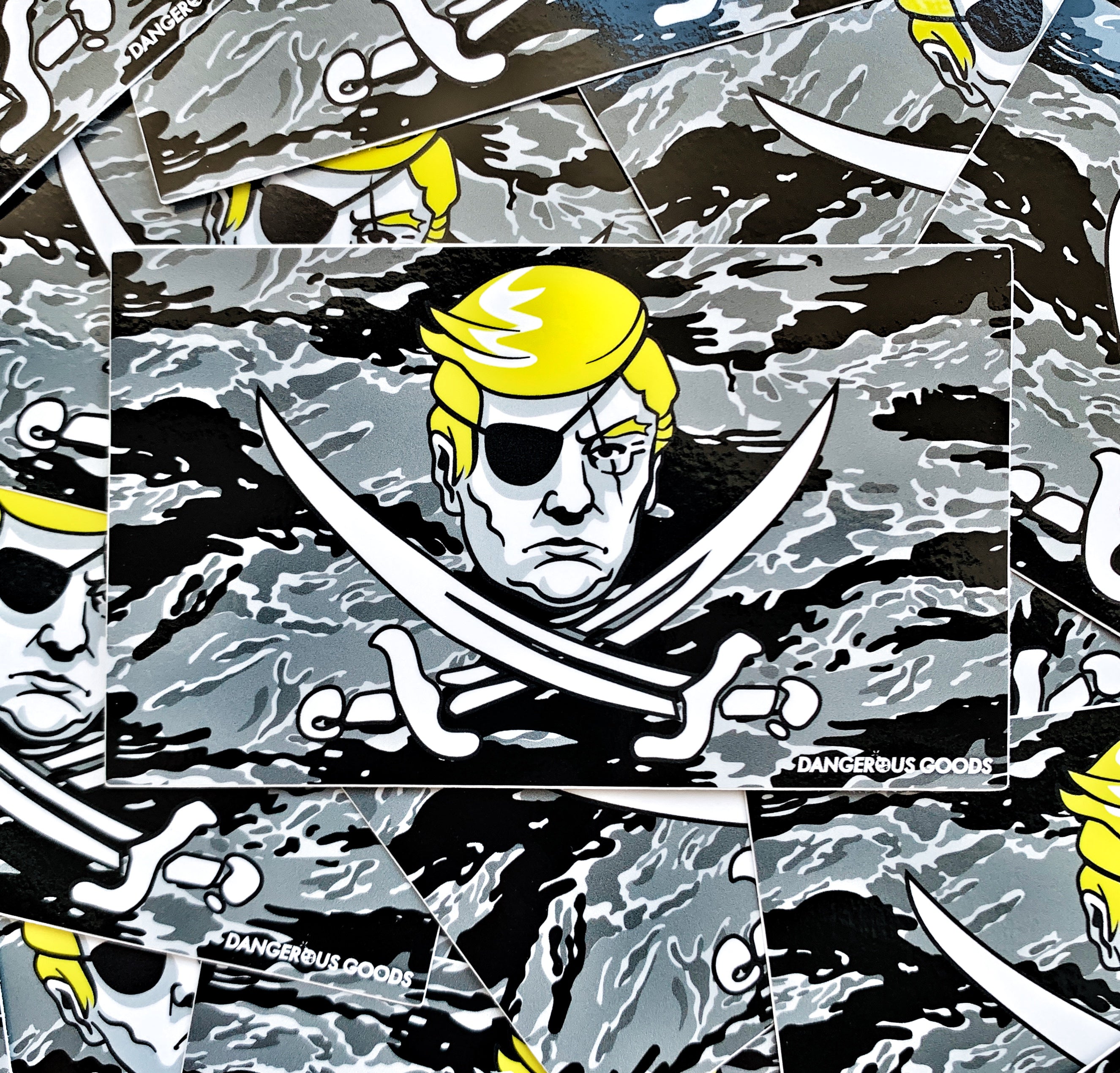 Black and grey tiger stripe camo style flag sticker depicting a cartoon image of trumps head with two crossing pirate swords underneath 