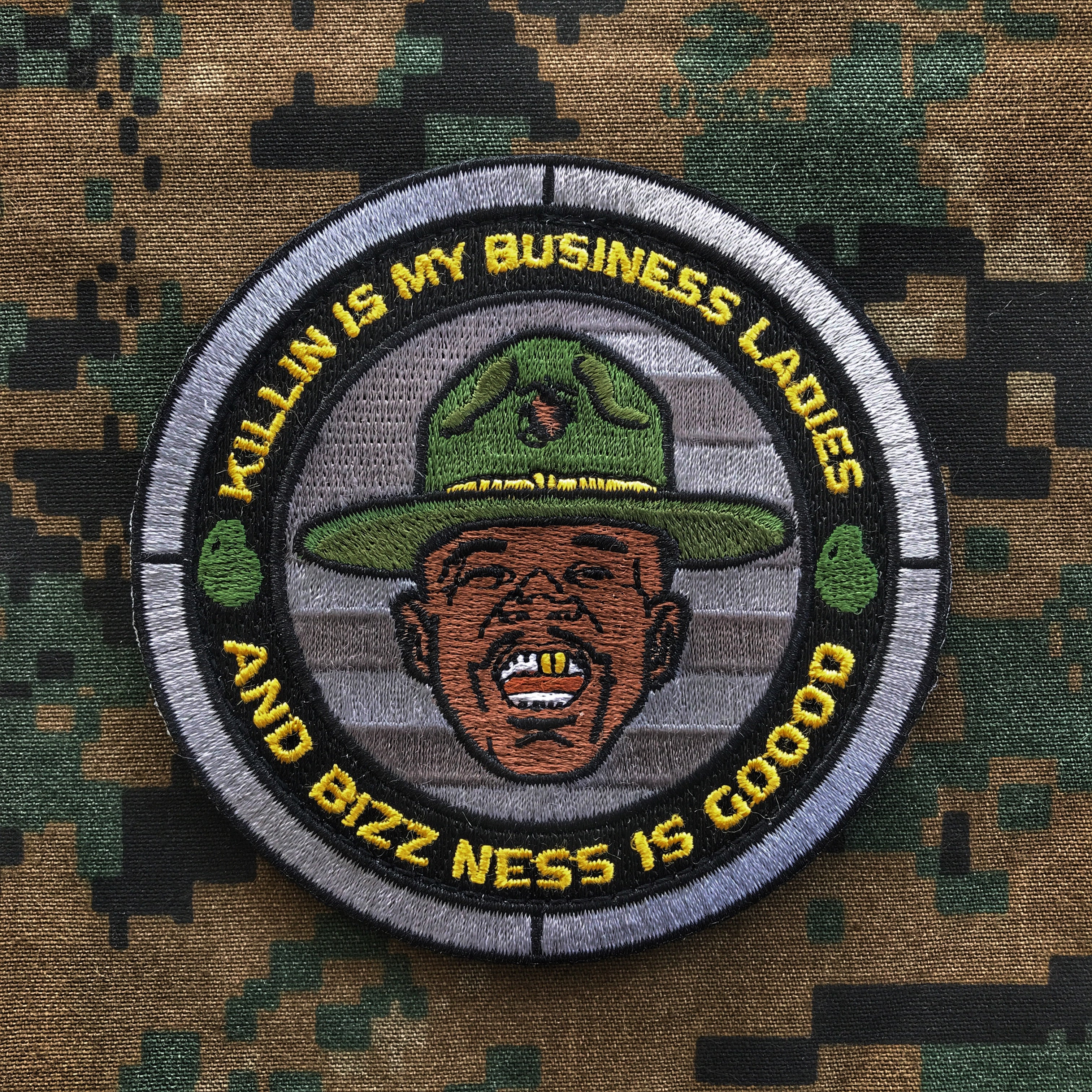 Embroidered round patch depicting a man’s head wearing a drill instructor hat with text that reads Killin is my business ladies and business is good