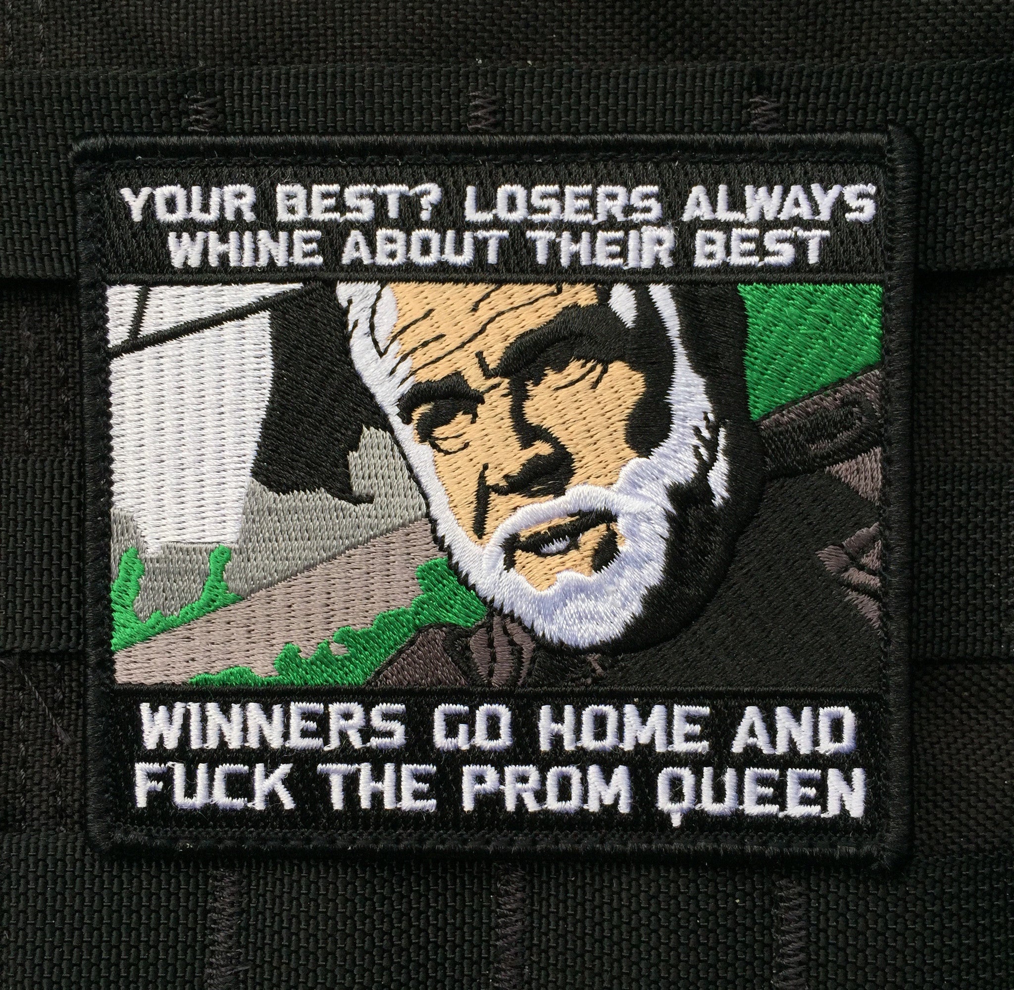 Black and white Embroidered patch with a man’s head in the middle and text above and below that reads Losers always whine about their best winners go home and fuck the prom queen